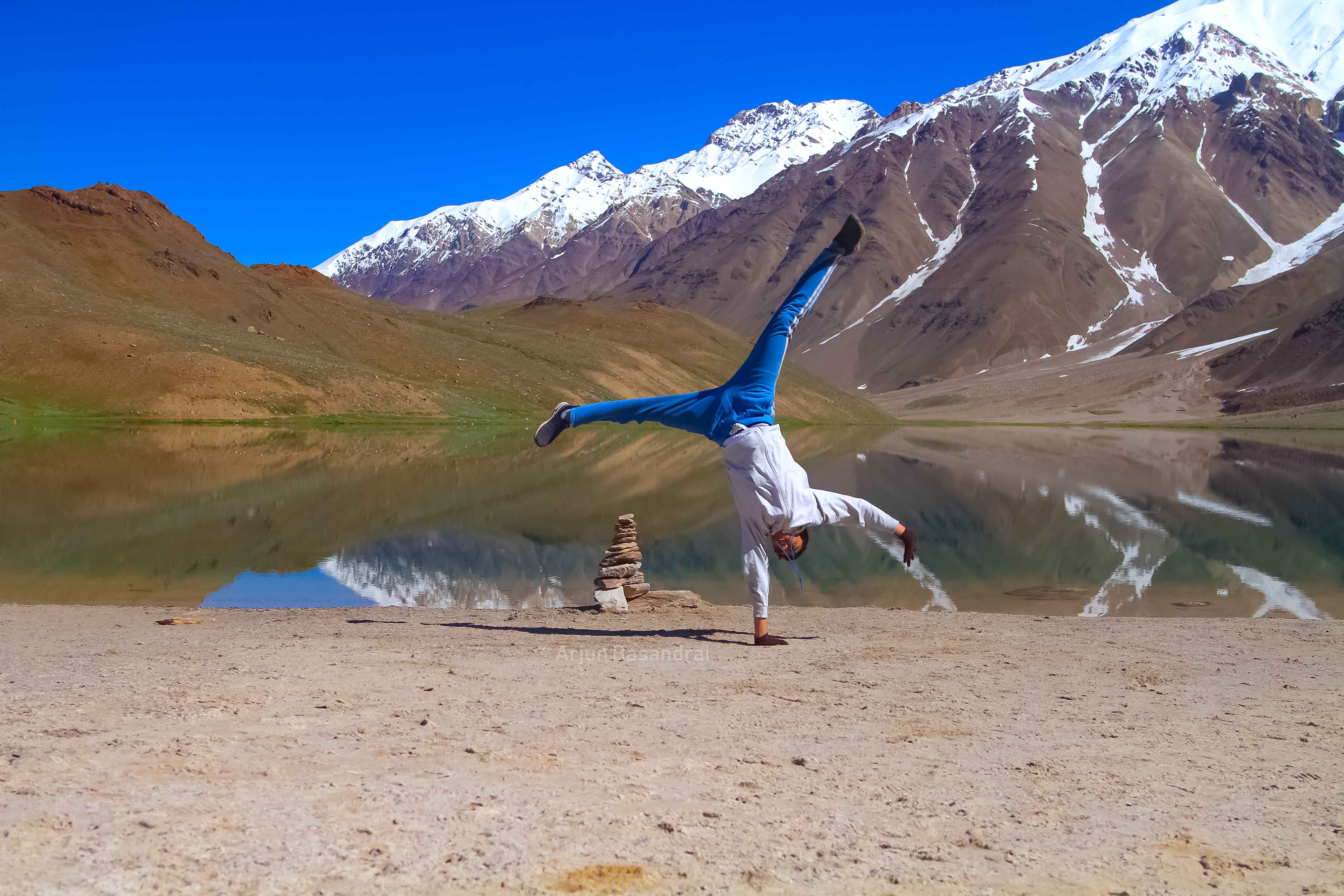 Arjun mid-cartwheel in front of Chandra Taal lake in Spiti